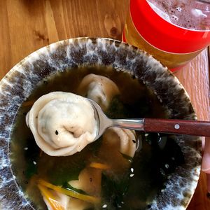 Miso soup with seaweed, carrots, sesame seeds and juicy vegan wontons stuffed with mushrooms, tofu and wakame at Azaza in Tula