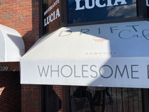 Outdoor awning sign says WHOLESOME  at Drift Cafe in Newport
