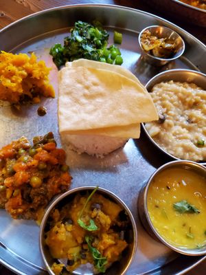 Vegetable thali platter with vegan rice pudding at Norbu in Lancaster