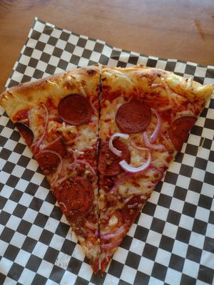 Slice is easier to handle if they cut it in half. Nice thin crust. at The Hungry Sasquatch in Vancouver