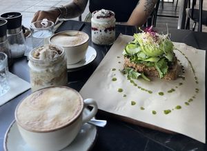 Overnight Oats und Avocado Sandwich + Flat white with Oatmilk 👌🏼  at Bakery Kafeneio in Limassol