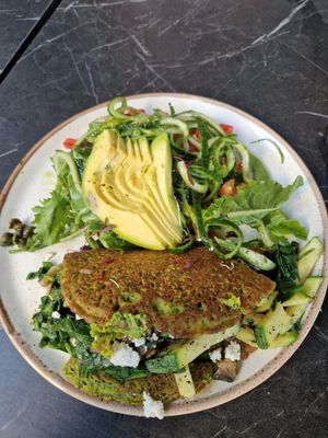 Vegan chickpea based omelette with feta cheese inside and greens. at Bakery Kafeneio in Limassol
