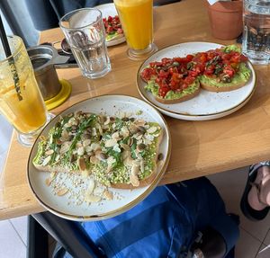 The two different kind of avocado toasts and freshly made orange juice  at Stolia in Shkoder