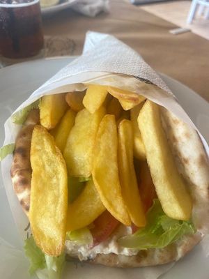 Vegan pita with hummus, tomato, onion salad and fries 🍟 at Aris in Planos