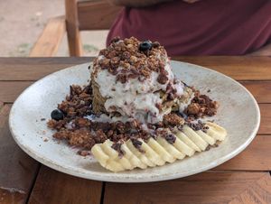 Quinoa almond flour pancakes with granola and coconut yogurt. So good! at Gracias Vida in La Guajira