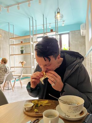 Burger is served with chips  at Go Vegan Cafe in Batumi