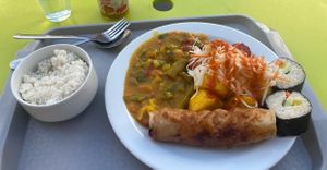 I got a random selection, but we have: rice, green curry, two rolls, a tofu spring roll, pickled cabbage and roast carrot and beets underneath :))  at Loving Hut - Vinohrady in Prague