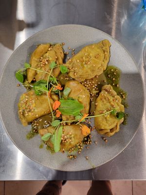 Pierogi z bobem i pieczonym kalafiorem, podawane z oliwą kolendrową i sosem na bazie marakuji i chilli at Green Vibes in Wroclaw