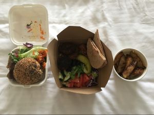 Bean and mushroom burger, veggie kofte mezze salad and wedges take out. at The Kitchen on Great Moor Street in Bolton