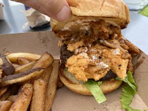 Deluxe homemade burger with organic fries; showing the cashew cheese  at Plantology in Gainesville