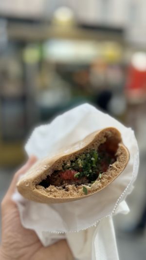 Pita stuffed with hummus and falafel   at Falafel + in London