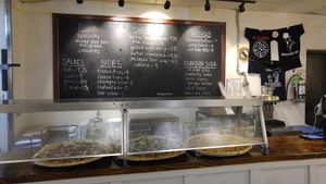 Pizzas and menu board at Blackbird Pizzeria - 6th St in Philadelphia