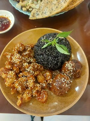 Black rice with orange chicken and tofu meatballs at Peanuts in Hoi An