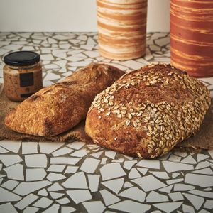 Canasta vegana including: oatmeal and brown rice bread, ciabatta, and almond cream at Tres Trigos - Laboratorio de Pan in Medellin