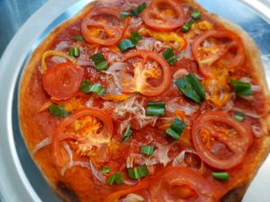 La colorá - juicy freshly cut tomato, onions, and organic coriander from our orchard. Tasty blocal vegan taste.   at Vegan Pizzeria in San Juan