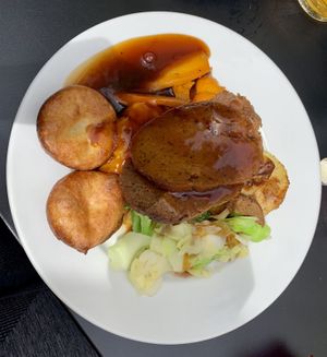 Vegan seitan roast with potatoes, carrots, cabbage, broccoli, mashed sweet potato, Yorkshire puddings and gravy! at Open House in Brighton