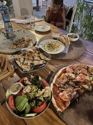 Vegan FEAST! Hummus board with an extra side of their crispy flat bread, house flat bread (no presto sub basil leaves), house salad, Mediterranean veggie pizza (no cheese)... at La Luna in Nosara