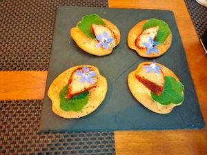 Almond cheese, cracker and fresh flowers at Espaço Vivo S Coop Galega in Redondela