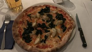 Pizza “vegetarienne” with vegan cheese, artichoke and spinach. All vegan pizzas are 14chf on mondays.  at L'Imprevu Cafe in Fribourg