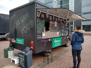 The food truck and a customer. at Thai Vegan Kitchen in Helsinki