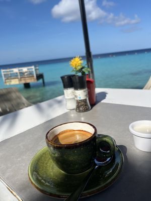 Strong coffee with soy milk with this view  at Karakter in Willemstad