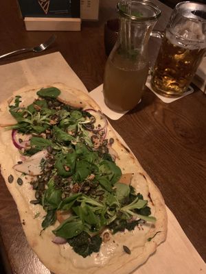 Pizza with spinach, sliced apple, onions, pumpkin seeds, basil and balsamic drizzle. And possibly a cashew cheese base.. A slightly sweet and savoury mix going on, very tasty   at Landwehr - Bräu am Turm in Rothenburg Ob Der Tauber
