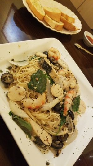 Sea Combination pasta dish with garlic bread! at Simple Joy in Honolulu