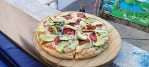 Margherita pizza with avocado mmm delicious at The Fifth Dimension in San Pedro La Laguna