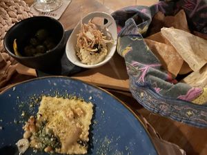 Stuffed ravioli and ‘bread with dip and olives). at Esfigueral in Ibiza