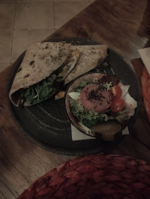 Piadina with Harissa Paste 🌶️, Arugula 🥬 and Grilled Aubergine 🍆 + Side Salad 🥗 at Esfigueral in Ibiza