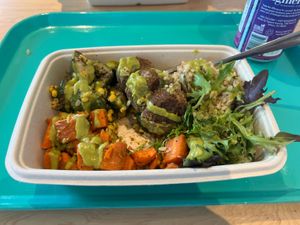 Veg fritters, carrot salad, zucchini salad all over brown rice and mixed greens with spicy avocado dressing   at Maepole in Atlanta