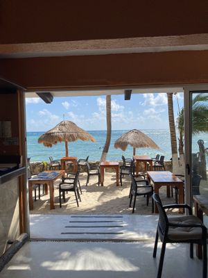 The view from the bar out to the tables and the Caribbean Sea  at La Lunita in Akumal