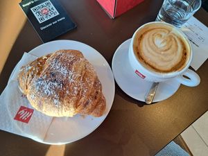 Vegan apricot croissant and soy cappuccino at Illy Caffé in Trieste