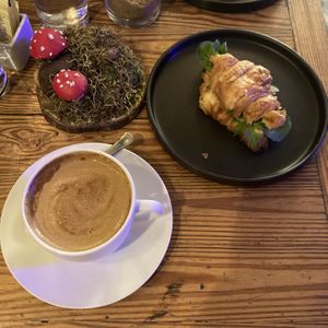 Capuchino con leche de almendras y croissant relleno con queso de caju y rucula   at Mushroom Bar in Montevideo