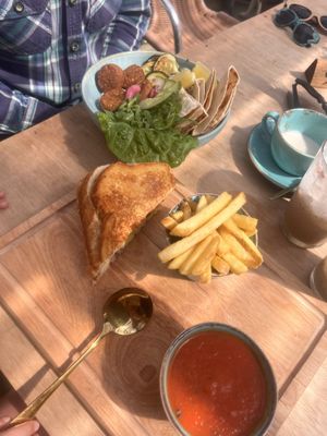 Falafel bowl and vegan tomato soup, chips and vegan cheese onion toastie   at Fins Beach Cafe in Sandown
