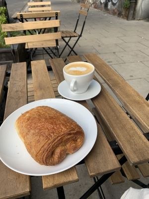pain au chocolat and latte at Massolit Books & Café in Krakow