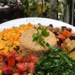 Feijoada with leguminous coconut chips, fried plantain, kale, farofa, orange, vinaigrette, brown rice at Pira na Banana in Sao Paulo