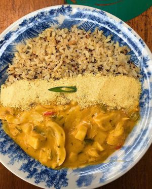 Banana stew, red, yellow and green pepper, palm oil, brown rice with quinoa, farofa at Pira na Banana in Sao Paulo