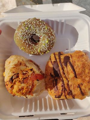 Pepperoni, cheese bread, pistachio raised donut, and chocolate croissant. at Timeless Coffee - Webster in Oakland