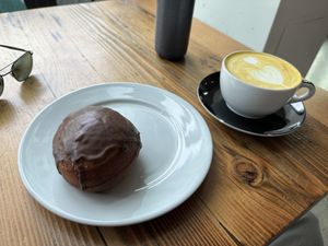 Chocolate jelly-filled donut and golden latte 😋   at Timeless Coffee - Webster in Oakland