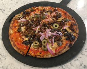 Delicious vegan stone oven pizza: Cauliflower crust, wild mushrooms, pickled onions, green olives, vegan Beyond Meat chorizo, vegan mozzarella cheese. at Mason Jar Kitchen in Eagan