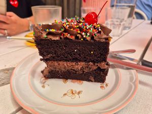 Someone's birthday cake: very pretty and moist but not much chocolate taste at Tyler's Milkbar in Preston