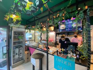 Interior with digital menu displaying burger and meal deal options at FunKink Burgers in Bucharest