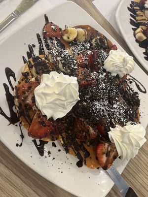 Pancakes with banana, strawberry, whipped cream, chocolate syrup, Oreo crumble (vegan)  at Amy's Dejeuner Brunch & Gaterie in Dollard-des-ormeaux
