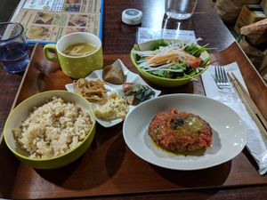 Lunch set menu with soy meat hamburger and various sides at Aju in Osaka