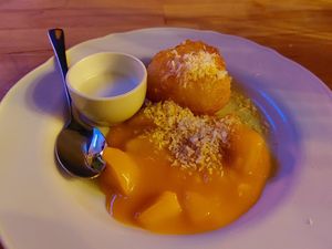 Sweet dumpling with mango and coconut cream at Café Tropical in Mannheim
