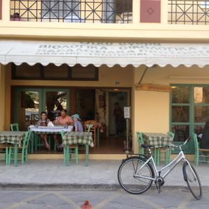 watch passers by and the playground from an airy outside table at To Stachi in Crete