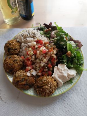 Chickpea patties with rice and salad at Fava Mercearia Café in Lagos