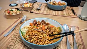 Chow Mein, Crispy Duck Chow Mein, Kung Pow Chicken, Malaysian Tofu Curry, Popcorn Tofu, and chips at Cheungs Vegan Kitchen in Bristol