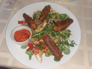 Vegan cevapcici with mixed green salad and ajvar at Kapos Restaurant in Kaposvar